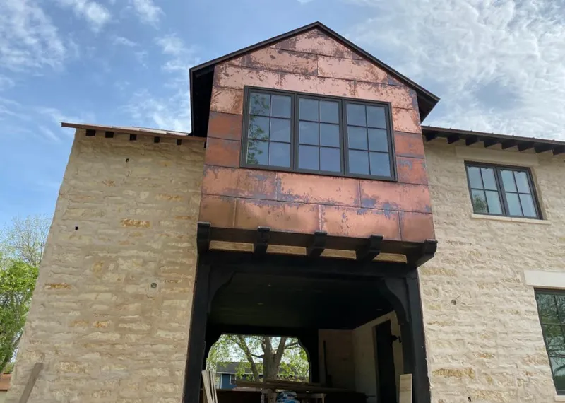 Copper metal panel facade on a stone building for Skylight Installation in Ewa Villages